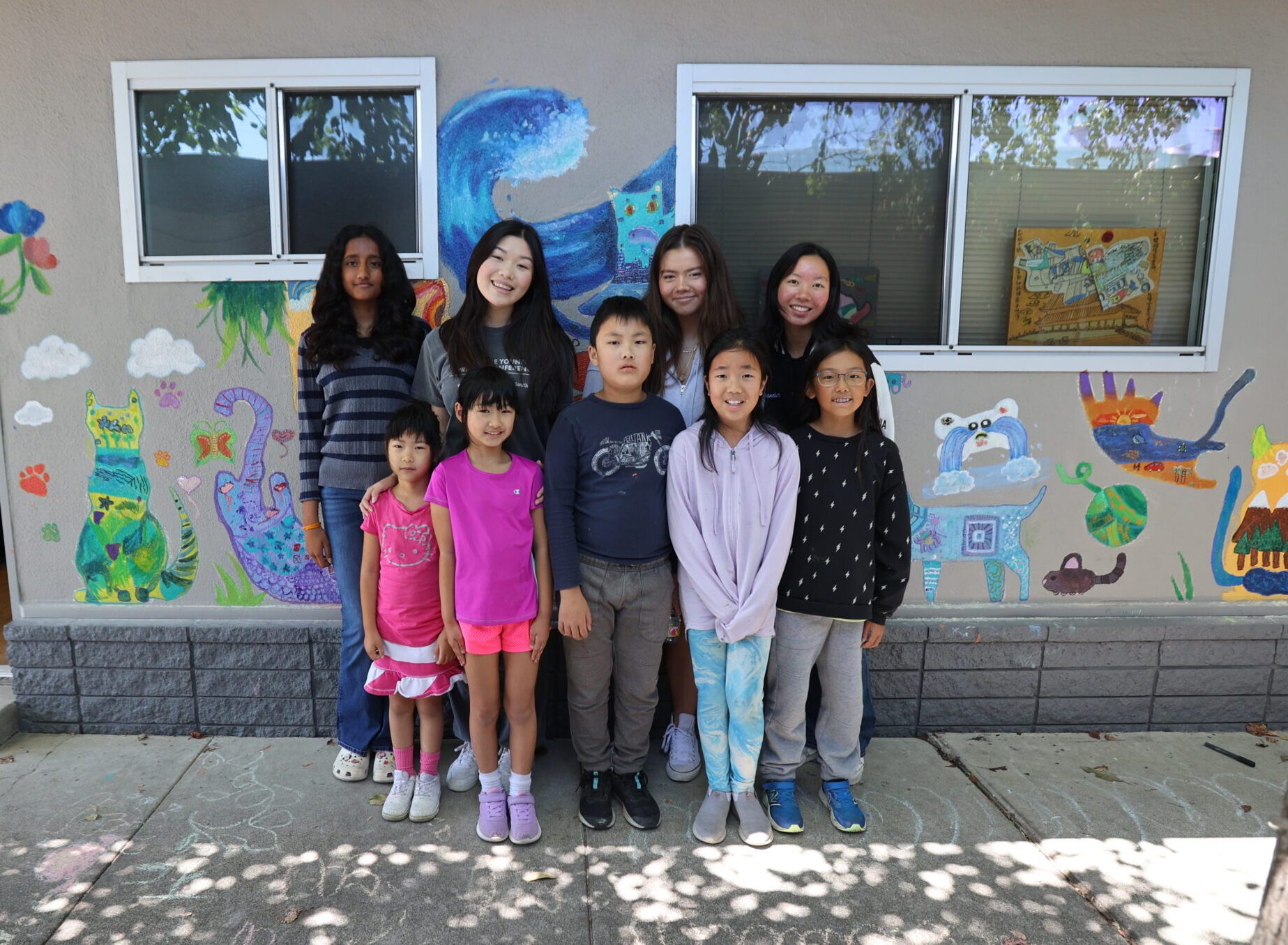 Young artists in front of their mural