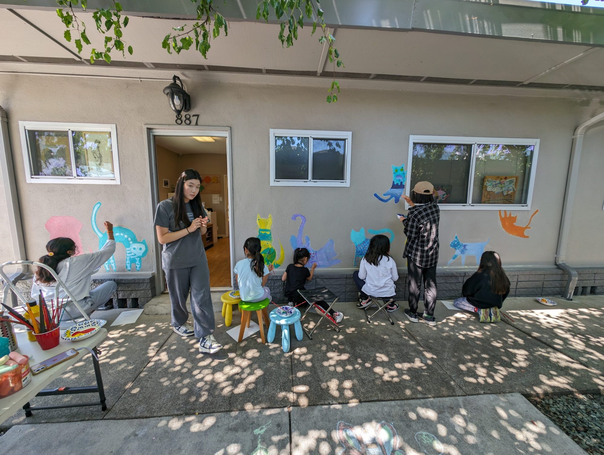 Young artists painting a community mural